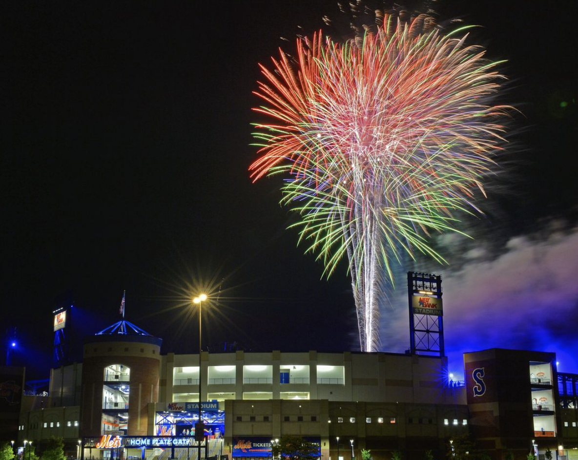 Fireworks going off above the NBT Bank baseball stadium